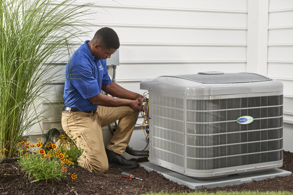 HVAC techs check AC outdoor cooling unit. 