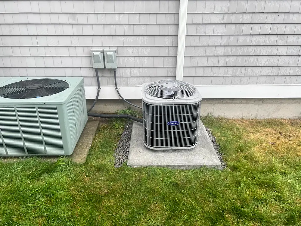 New Carrier HVAC unit installed in Newport, RI by National Refrigeration, next to existing condenser